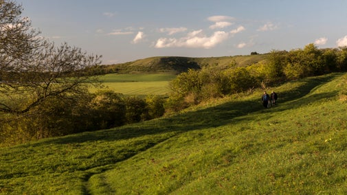 Two people walking in spring across Dunstable Downs, Bedfordshire